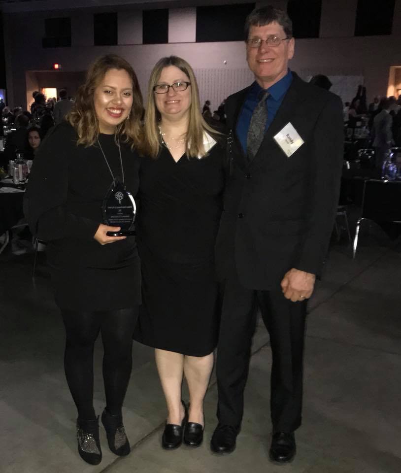 Ixayana Gonzales poses with Tami and Randy Kruzel after receiving the 2018 Growing Up Big Award