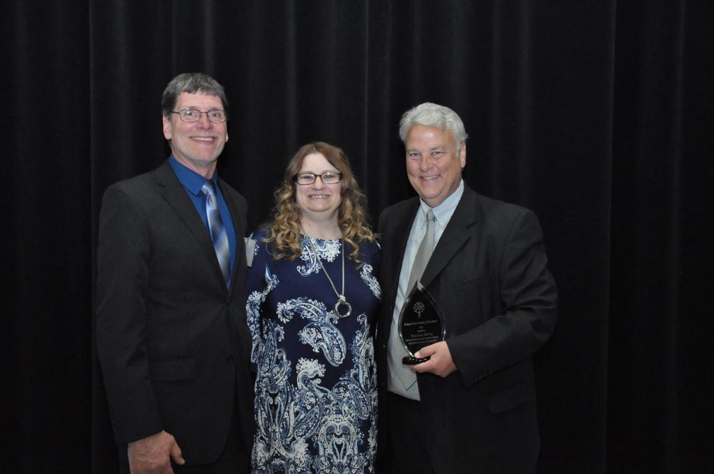 Vince Mohs poses with Tami and Randy Kruzel after receiving the 2019 Growing Up Big Award
