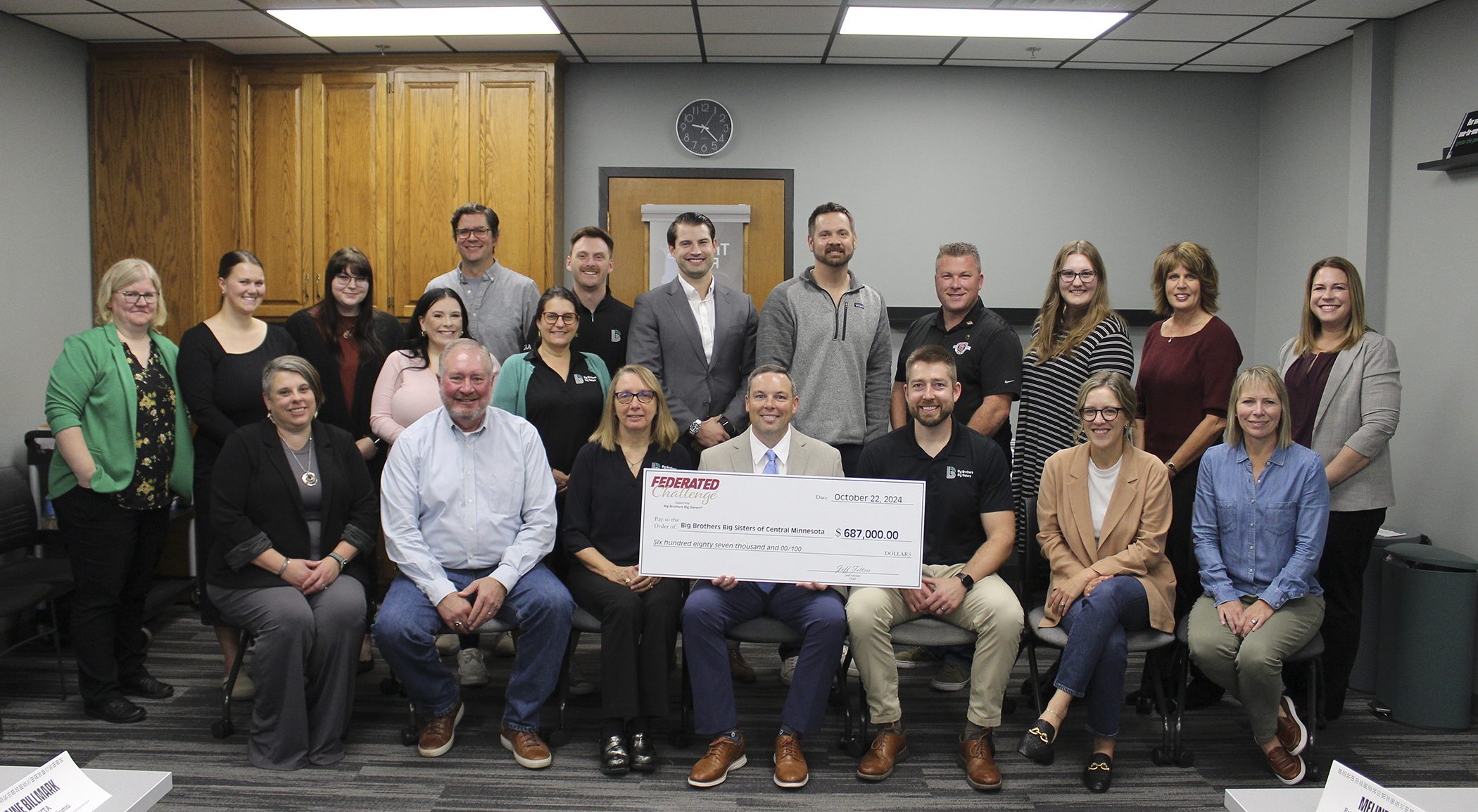 Federated Insurance Vice President Roger Bailey presents BBBS staff and board with a check from the Federated Challenge